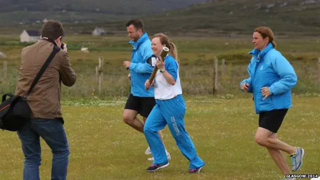 Marion Lindsay Steele carries the Glasgow 2014 Queen's Baton through Daliburgh/Dalabrog on South Uist in the Outer Hebrides.