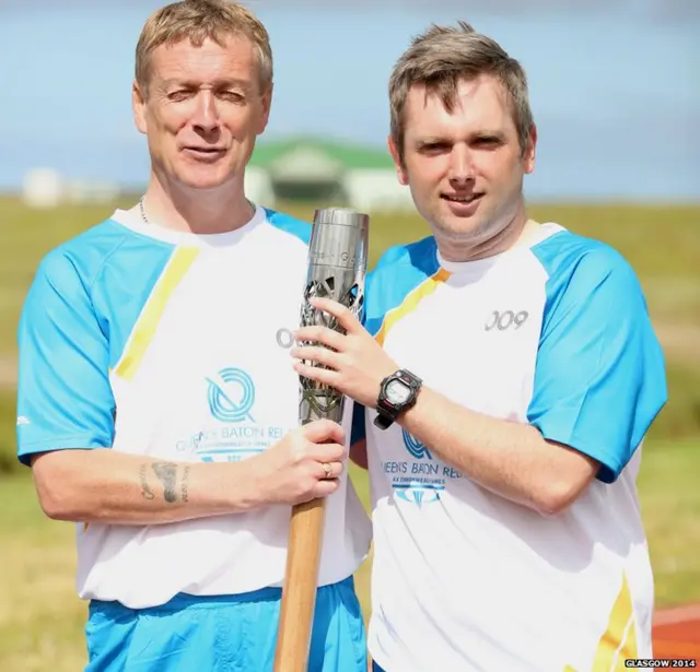 Christopher Bennett hands the baton to Iain MacDonald