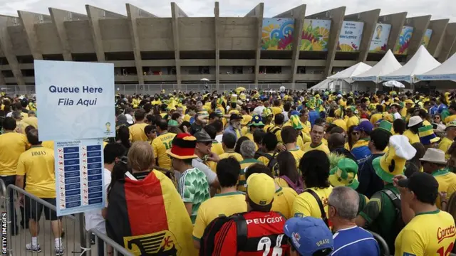 Fans queue outside the Mineirao Stadium in Belo Horizonte before the semi-final football