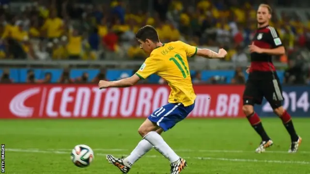 Oscar of Brazil shoots and scores his team's first goal