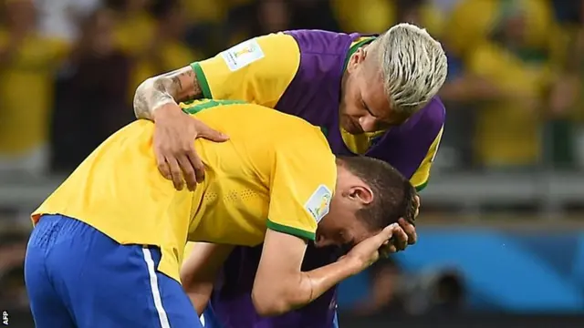 Brazil defender Dani Alves consoles forward Oscar