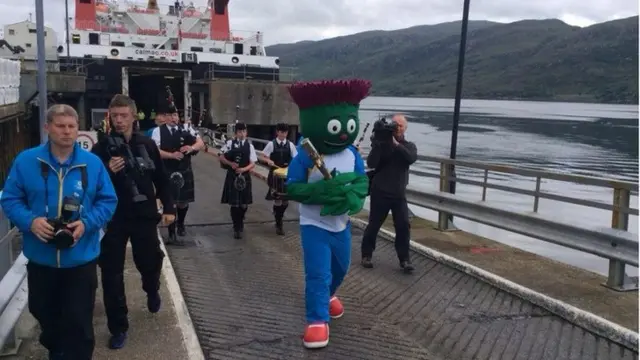 Mascot carries the baton off the ferry