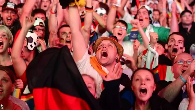 Germany fans cheer during a public viewing at the Brandenburg Gate in Berlin on July 8, 2014.