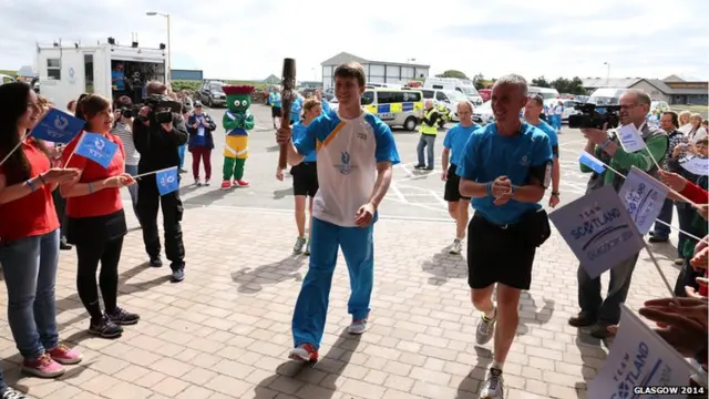 David Porteous carries the Glasgow 2014 Queen's Baton at Stromness Academ