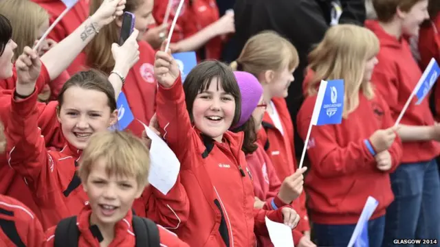 Cheering children all waving flags