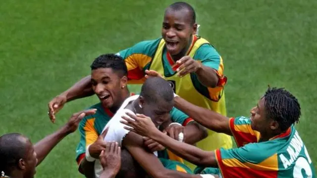 Senegal's Henri Camara is mobbed by team-mates after scoring the winning goal against Sweden in extra time during their 2002 World Cup second-round playoff match