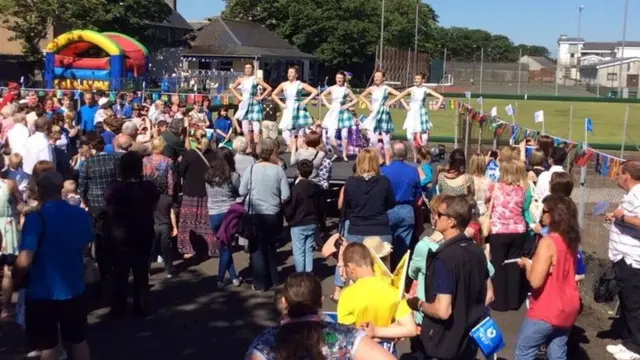 Crowd watches some girls performing a Highland dance