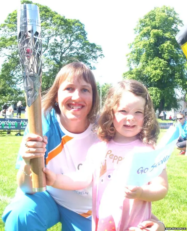 Baton bearer Kirsteen MacKenzie poses with young girl