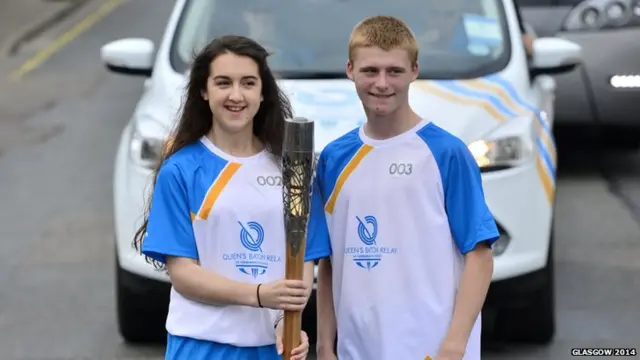 Nicole Smith and Brendan MacDonald pose with Queen's baton