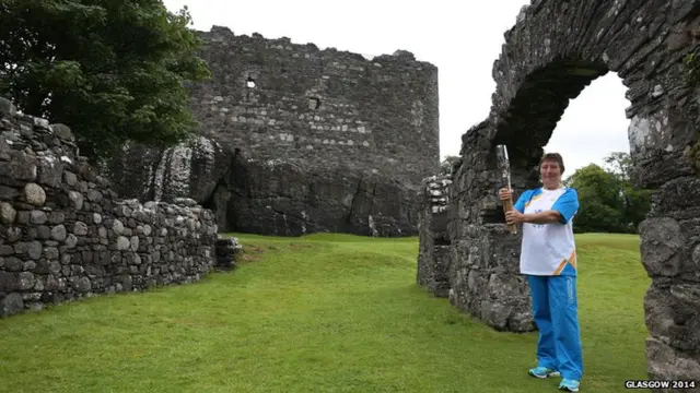 Jacqueline Parker carries the baton at Dunstaffnage Castle