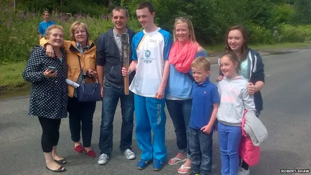 Baton bearer Liam Logan and family