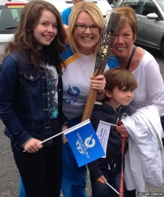 Jillian Gibson with family and baton