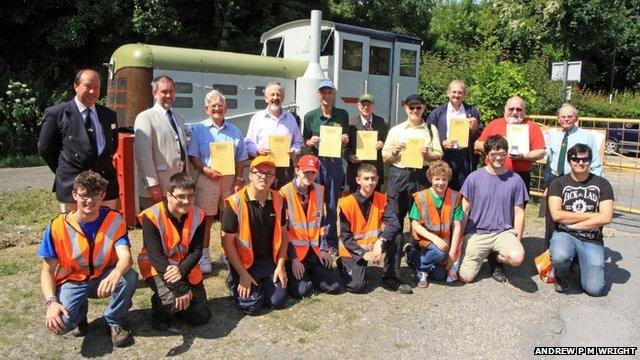 Swanage Railway volunteers with their certificates and members of the railway's Cygnets youth group who have been restoring May - the locomotive which hauled the first passenger trains in 1979