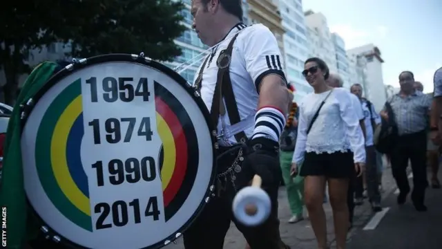 Germany fan with drum depicting the previous years they won the World Cup - plus 2014