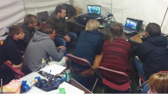 Fans watching laptop