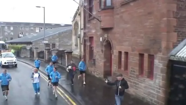 Margaret Watson carries the baton in Port Glasgow