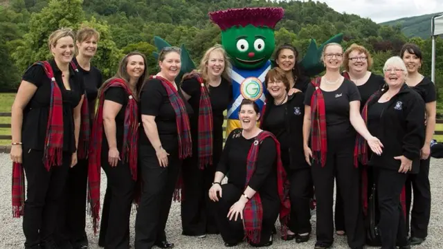 Choir pose with the baton