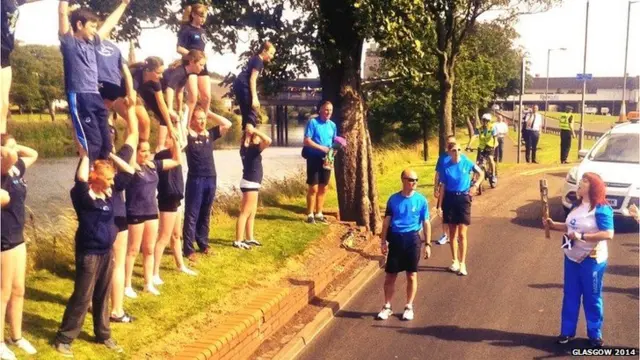 Gymnasts watch the baton relay