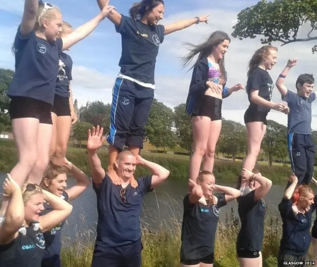 Gymnasts watch the baton relay