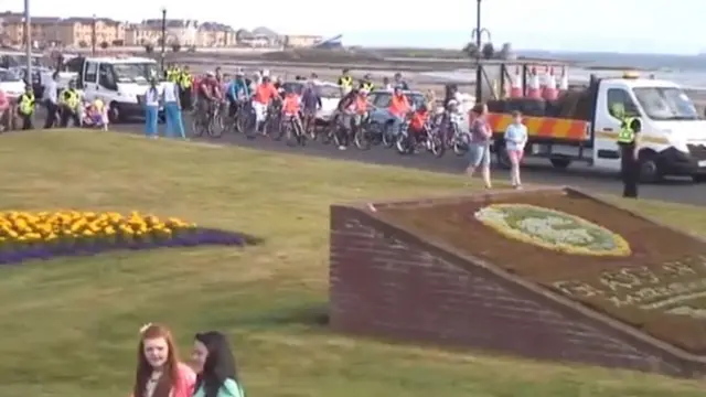 A group of cyclists with the convoy