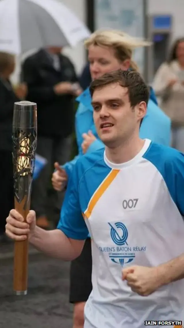 Stuart McDougall with the Queen's Baton in Neilston