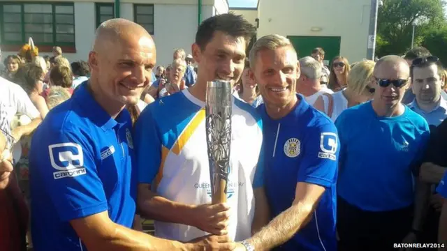 Baton bearer Kenneth Bain poses with Gary Teale and Jim Goodwin