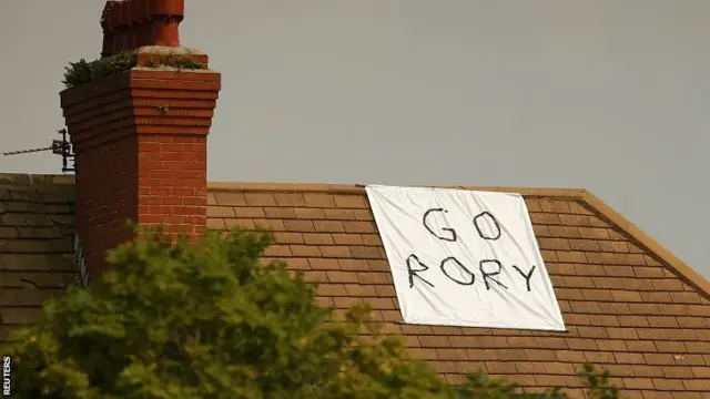 Fans display a message that reads "Go Rory" for Rory McIlroy of Northern Ireland, on the roof of a house