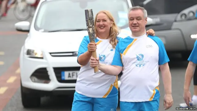 Ian Shillinglaw hands the baton to Jacqueline Smith