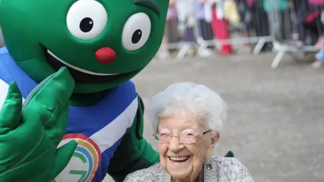 Mascot Clyde with smiling elderly lady