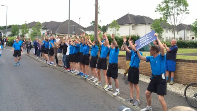 Police officers support baton bearers