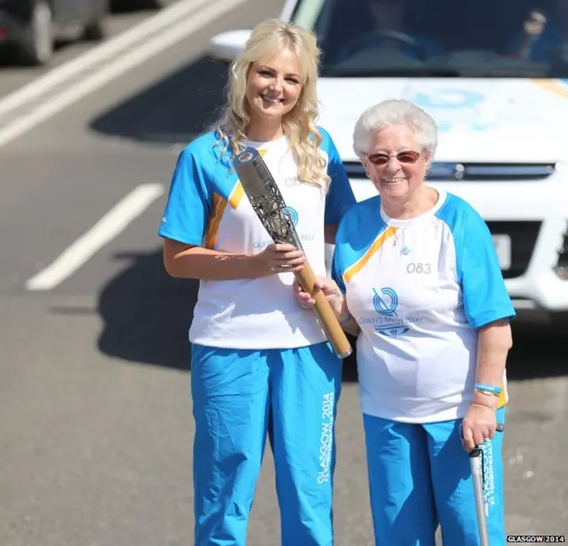 Flora Pagan hands the baton Peri Wallach.