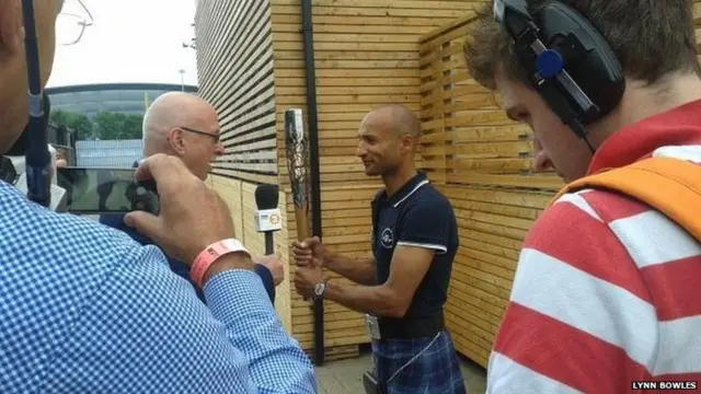 Radio presenter Ken Bruce interviews Steve Frew, who is holding Queen's baton