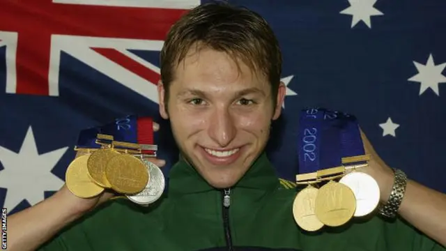 Australian swimmer Ian Thorpe with his medal haul from the 2002 Commonwealth Games