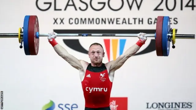 Gareth Evans of Wales makes a successfull lift as he competes in the Men's 62kg Group B Weightlifting