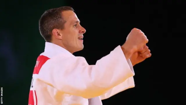 Euan Burton of Scotland defeats Shah Hussain Shah of Pakistan in the Men's +100kg Judo gold medal final