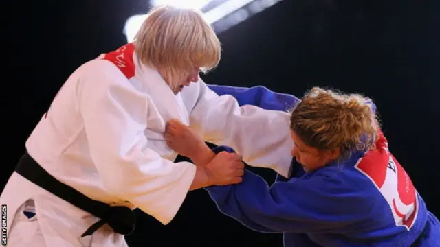 Sarah Adlington of Scotland (white) competes against Jodie Myers of England in the Womens +78kg Judo gold medal final