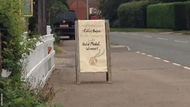 Judo player Colin Oates spots congratulations sign outside local pub