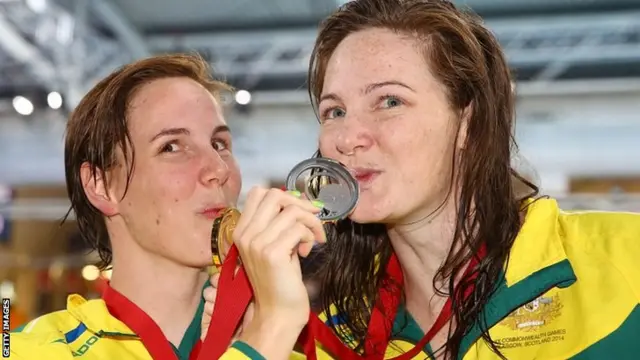 Women"s 100m freestyle gold medallist Cate Campbell (right) of Australia poses with her sister and silver medallist Bronte Campbell (left) after their medal ceremony