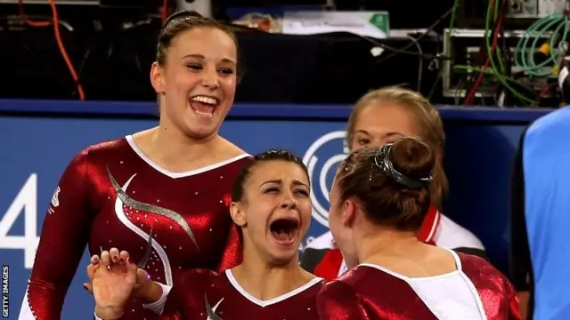 Gold medallist Claudia Fragapane (C) of England celebrates with silver medallist Ruby Harrold (R) of England and bronze medallist Hannah Whelan