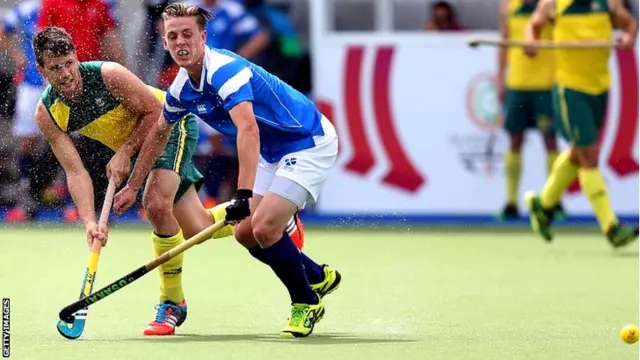 Australia's Matt Gohdes, left, hits the ball past Scotland's Michael Bremner