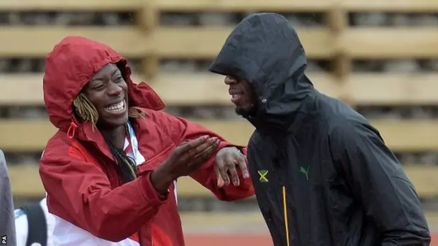 Usain Bolt with Christine Ohuruogu on the warm-up track at Hampden Park