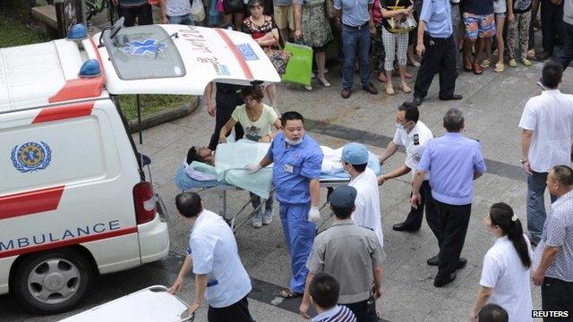 Man injured in Kunshan factory explosion being put into ambulance