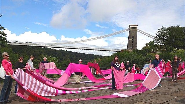 A 100m (328 ft) long pink scarf unveiled in Bristol