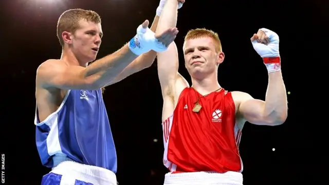 Charlie Flynn (R) of Scotland celebrates winning the gold medal against Joe Fitzpatrick of Northern Ireland