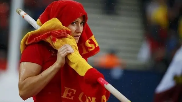 A pole vaulter in the rain