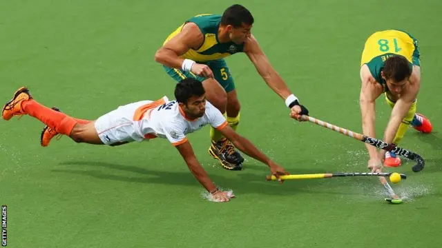 Chandanda Nikkin Thimmaiah of India (L) battles with Chris Ciriello (C) and Tristan White (R) of Australia