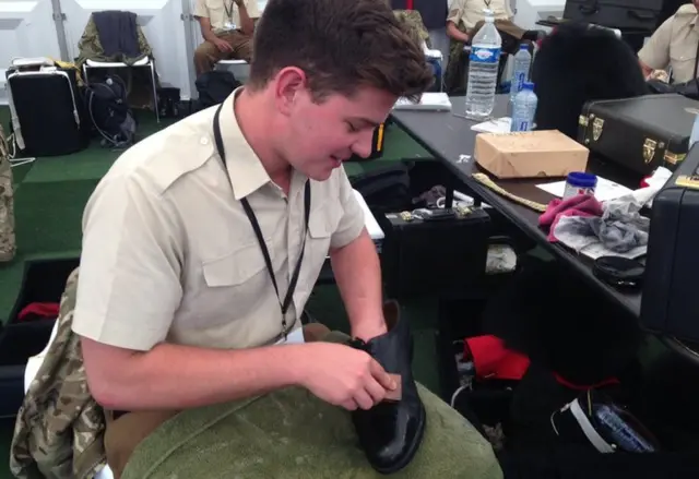 Musician Robert Blencowe of the Coldstream Guards applying spit and polish to his boots ahead of tonight's ceremony at St Symphorien Cemetery in Mons