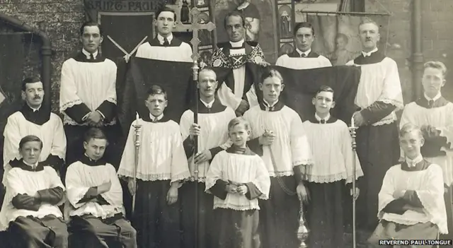 Reverend Geoffrey Studdert Kennedy, robed, known as "Woodbine Willie"
