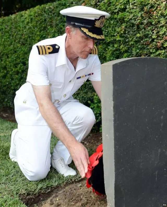 HMS Iron Duke Commanding Officer, Commander Tom Tredray lays his wreath at a War Cemetry near to Sekondi, Ghana