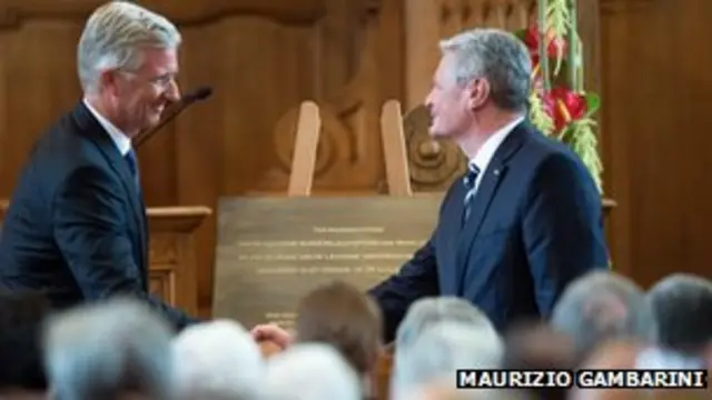 German President Joachim Gauck (R) and Belgian King Philippe (L) shake hands